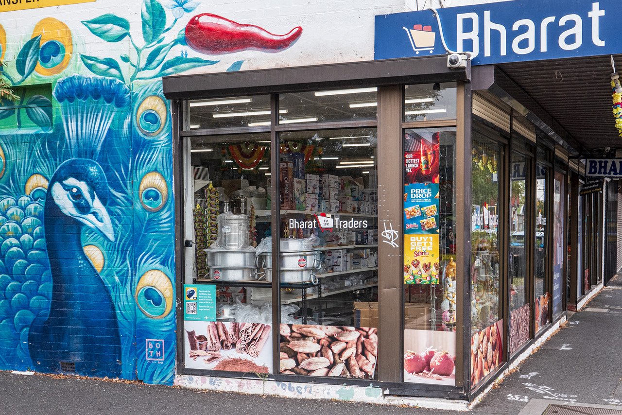 Bharat Traders shopfront with a colourful peacock mural